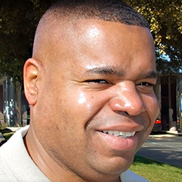 Young African American male wearing ear prosthesis in sunlight