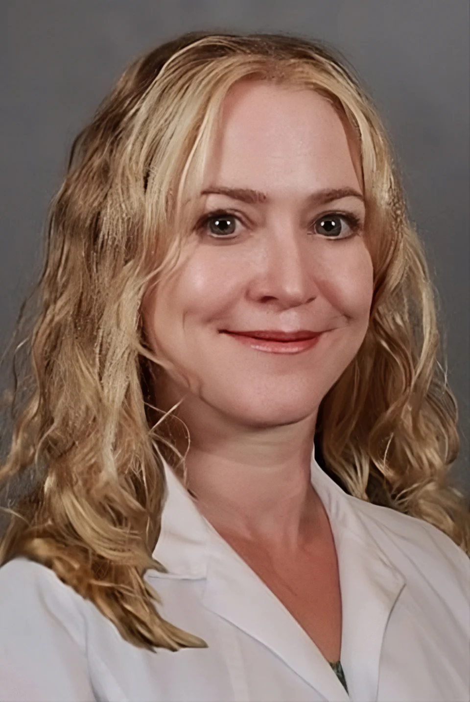 A woman with blonde hair and green eyes.