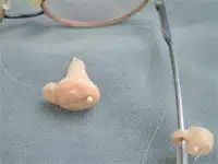 A close up of an ear with a needle in it