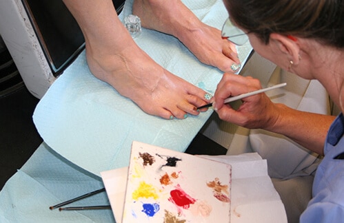 A person painting their nails with paint.