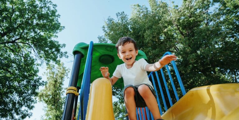 a boy on a playground slide
