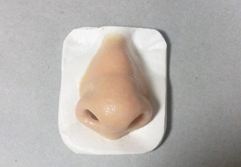 a plastic nose on a white surface